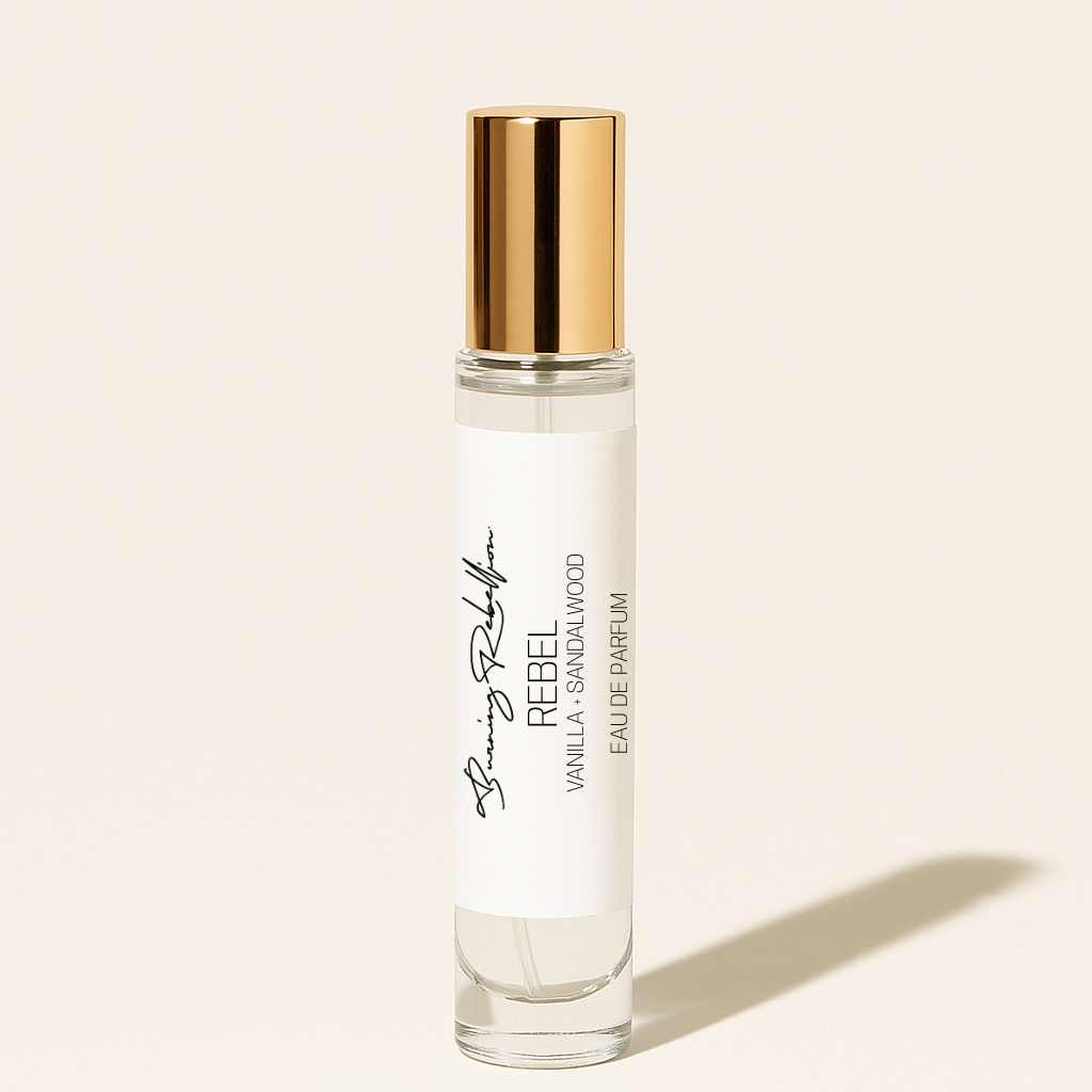 Perfume bottle with gold cap on a beige background