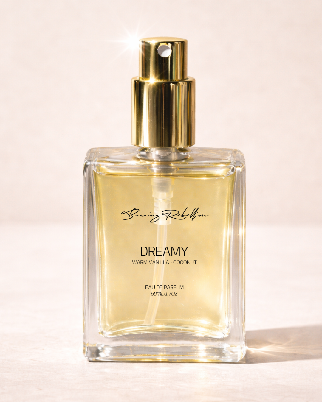 Perfume bottle labeled 'Dreamy' with gold cap on a light background