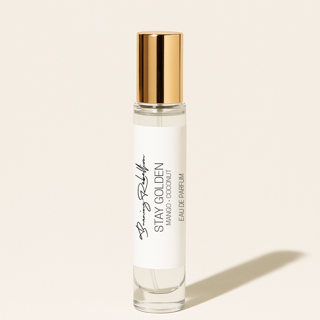 Perfume bottle with gold cap on a beige background